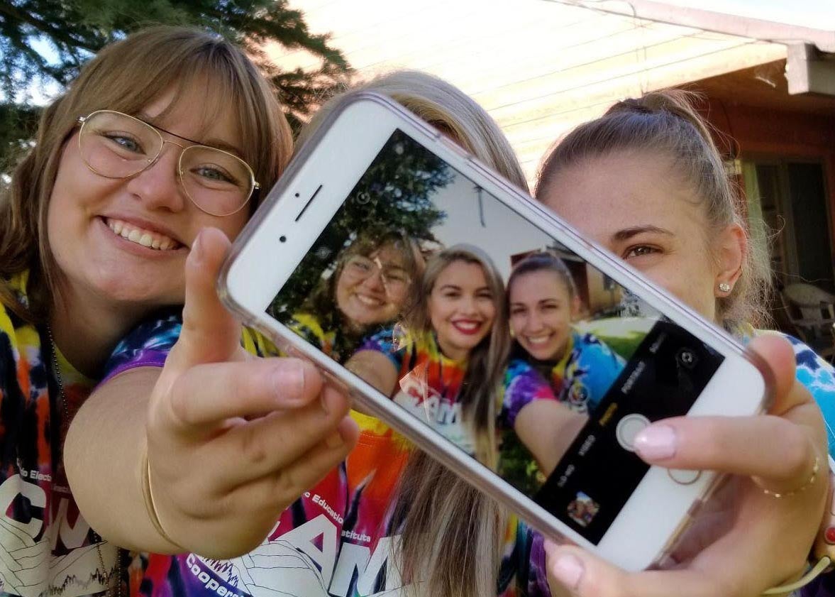 Three campers take a group selfie