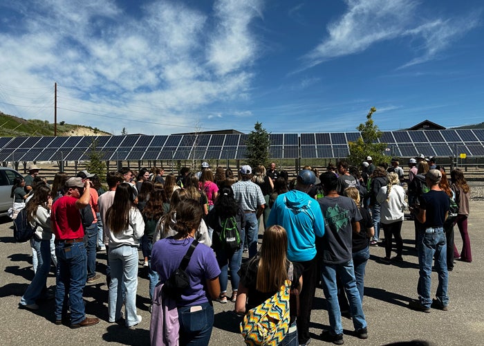 Campers tour a solar farm to learn about solar renewable energy generation