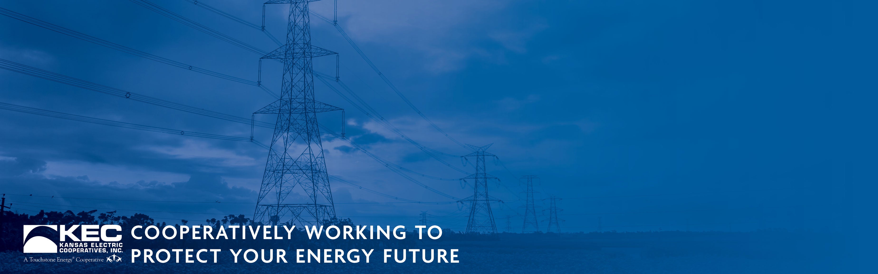 A landscape featuring electrical transmission towers against a cool blue sky. The image includes the text ‘KEC COOPERATIVELY WORKING TO PROTECT YOUR ENERGY FUTURE,’ highlighting the commitment to energy sustainability.