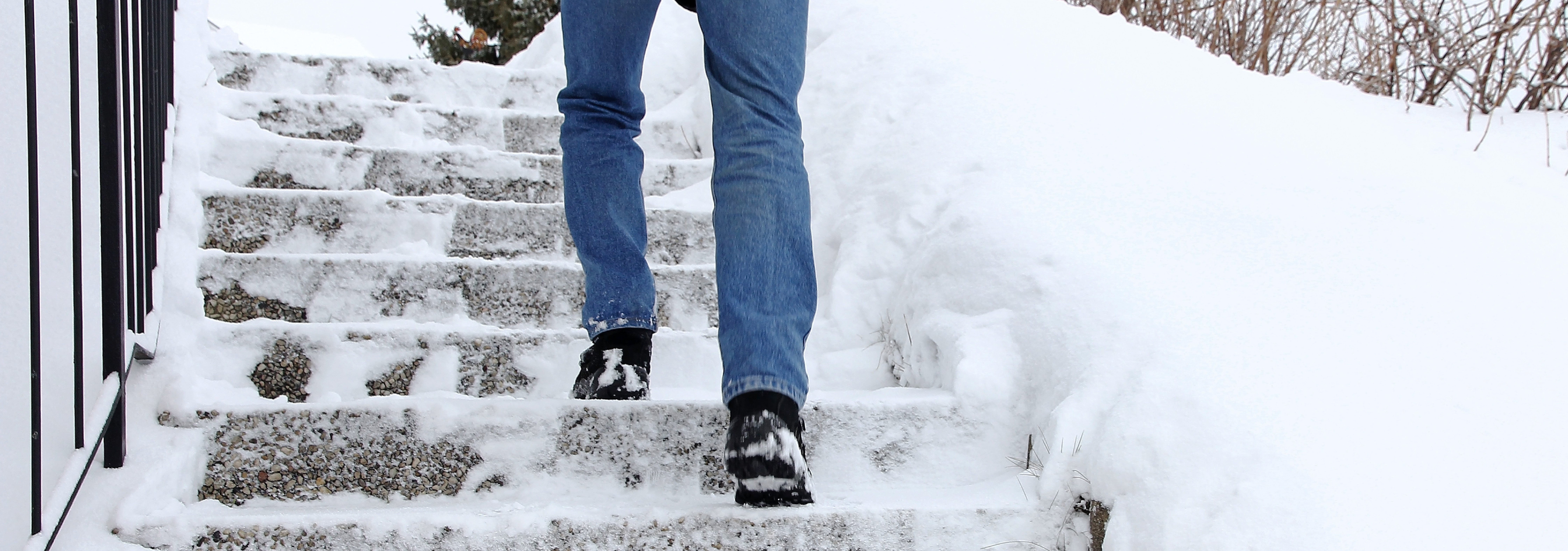Man walking up snow covered steps